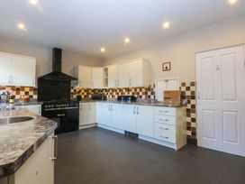 A kitchen with cabinets and a stove at Southbourne Manor in Llandudno