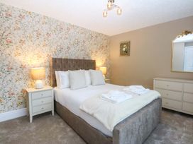 A bedroom with a bed and nightstands at Southbourne Manor in Llandudno