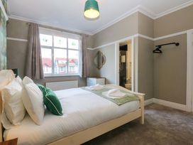 A bedroom with a bed and a window at Southbourne Manor in Llandudno