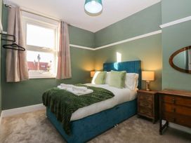 A bedroom with a bed and nightstand at Southbourne Manor in Llandudno