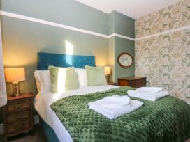 A bedroom with a bed and bedside tables at Southbourne Manor in Llandudno