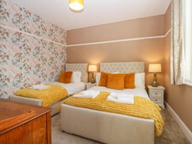 A bedroom with two beds and bedside tables at Southbourne Manor in Llandudno