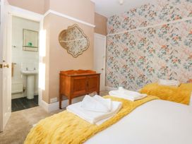 A bedroom with a bed and a dresser at Southbourne Manor in Llandudno
