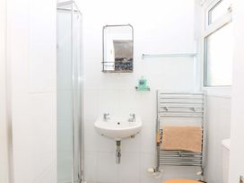 A bathroom with a shower, sink, and toilet at Southbourne Manor in Llandudno