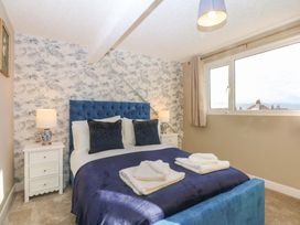 A bedroom with a bed and bedside tables at Southbourne Manor in Llandudno