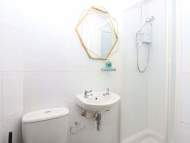 A bathroom with a sink, toilet and shower at Southbourne Manor in Llandudno