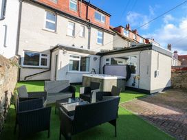 A garden with seating area and hot tub at Southbourne Manor in Llandudno