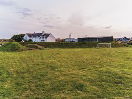 A field with a goal and nearby houses at Glanllyn Bach in Llanfaelog