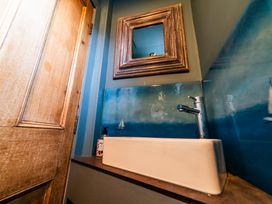 A bathroom with a sink and mirror at Glanllyn Bach in Llanfaelog