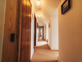 A hallway with doors and light fixtures at Glanllyn Bach Llanfaelog