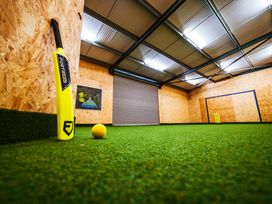 A sports training facility with a cricket bat, ball, and goal posts at Glanllyn Bach, Llanfaelog