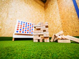 A game area with Connect Four and wooden blocks at Glanllyn Bach in Llanfaelog