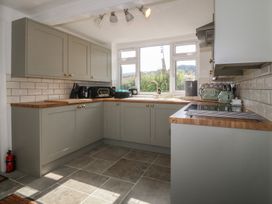 A kitchen with cabinetry and appliances at Tan Y Merddyn in Ceunant near Llanrug