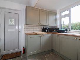 A kitchen with cabinets and appliances at Tan Y Merddyn in Ceunant near Llanrug