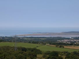A coastal landscape with water and fields at Tan Y Merddyn Ceunant near Llanrug