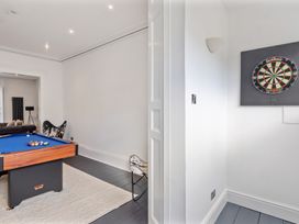 A games room with a pool table and dartboard at 8 Richmond Road in Exeter