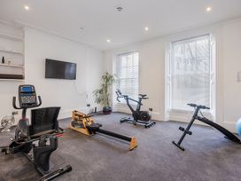A home gym with exercise equipment including a rowing machine stationary bike and ab bench at 8 Richmond Road in Exeter