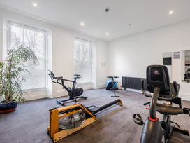 A gym room with exercise bikes rowing machine exercise ball and plant at 8 Richmond Road in Exeter