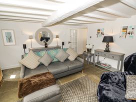 A living room with a sofa and table at Cotstone Cottage in Chipping Campden