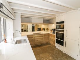 A kitchen with cabinets and appliances at Cotstone Cottage in Chipping Campden
