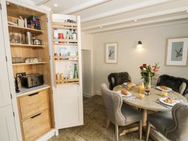 A dining room with a table set for breakfast at Cotstone Cottage in Chipping Campden