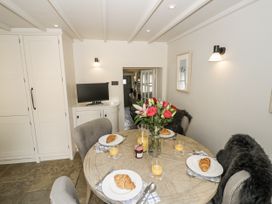 A dining room with a table set for breakfast at Cotstone Cottage Chipping Campden