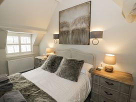 A bedroom with a bed and bedside tables at Cotstone Cottage in Chipping Campden