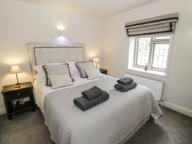 A bedroom with a bed and nightstand at Cotstone Cottage in Chipping Campden