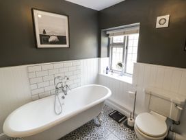 A bathroom with a bathtub and toilet at Cotstone Cottage in Chipping Campden