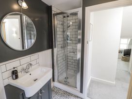 A bathroom with a shower and sink at Cotstone Cottage in Chipping Campden