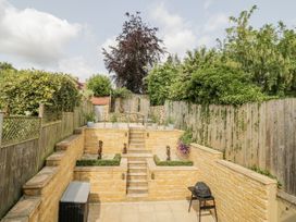 A garden with stairs and decorative features at Cotstone Cottage in Chipping Campden
