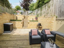 A garden with steps and seating at Cotstone Cottage in Chipping Campden