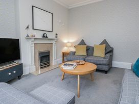 A living room with a sofa and coffee table at The Thistles in Bowness-On-Windermere