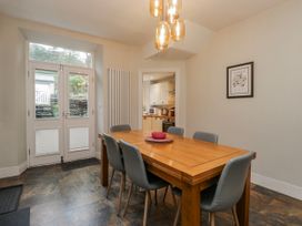A dining room with a table and chairs at The Thistles Bowness-On-Windermere