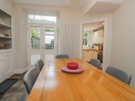 A dining room with a wooden table and chairs at The Thistles Bowness-On-Windermere