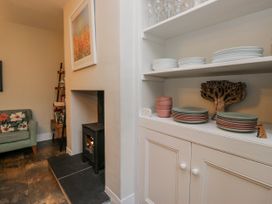 A living room with a sofa and fireplace at The Thistles Bowness-On-Windermere