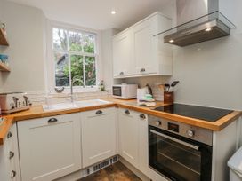 A kitchen with a sink and stove at The Thistles in Bowness-On-Windermere