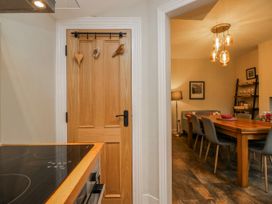 A kitchen with a door leading to a dining area at The Thistles Bowness-On-Windermere