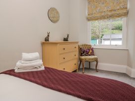 A bedroom with a bed and a chest of drawers at The Thistles in Bowness-On-Windermere