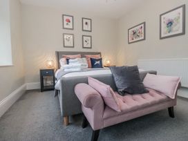 A bedroom with a bed and artworks on the wall at The Thistles Bowness-On-Windermere