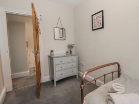 A bedroom with a bed and a bedside table at The Thistles Bowness-On-Windermere