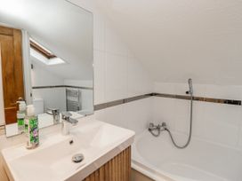 A bathroom with a sink and bathtub at The Thistles Bowness-On-Windermere