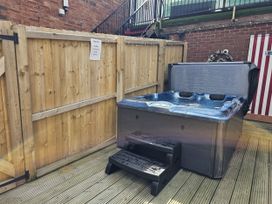A hot tub with steps in a garden at Circus Circus in Holywell