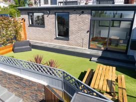A garden featuring seating area and patio at Seaview House Llanfairfechan