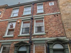 A building facade with brick walls and windows at Jolly Roger in Whitby