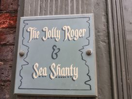 A sign for The Jolly Roger and Sea Shanty in Whitby