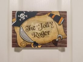 A decorative sign with pirate theme at Jolly Roger in Whitby