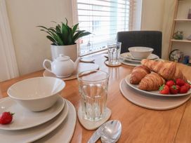 A dining table set with dishes, glasses, and food items at Jolly Roger in Whitby