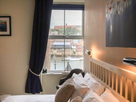 A bedroom with a view of the harbor at Jolly Roger in Whitby