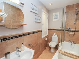A bathroom with a tub, sink, and toilet at Jolly Roger in Whitby